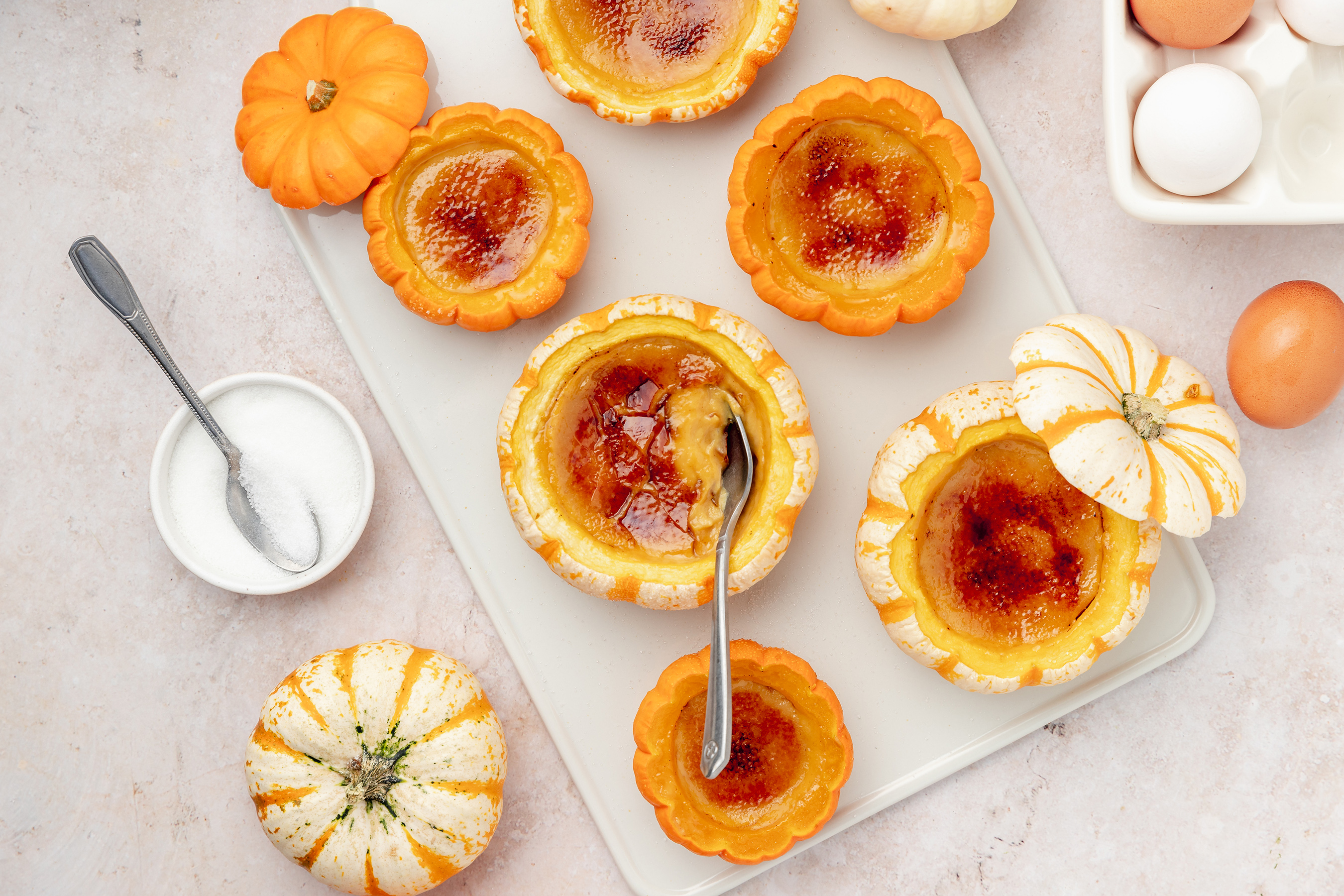 Love pumpkin spice flavors? Try out a surprisingly simple pumpkin crème brûlée baked in mini pumpkins.